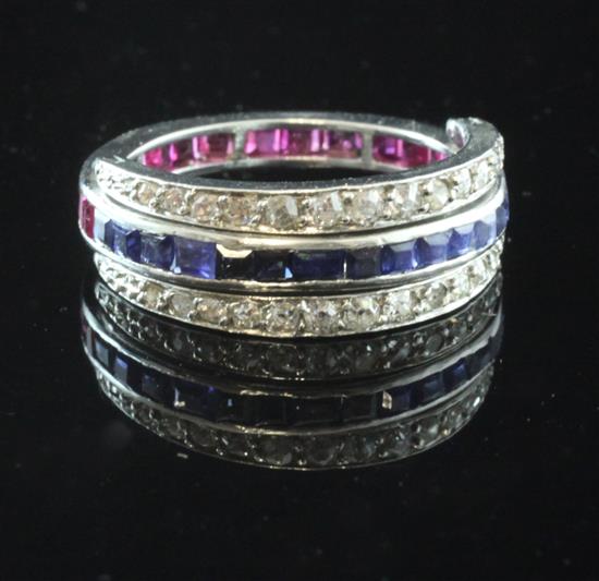 A white gold triple band ruby, sapphire and diamond eternity ring, size M.